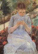 Young woman sewing in the Garden